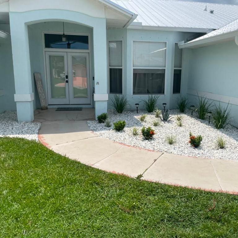 Rock bed redesign with new plantings at a Royal Palm Beach, FL home