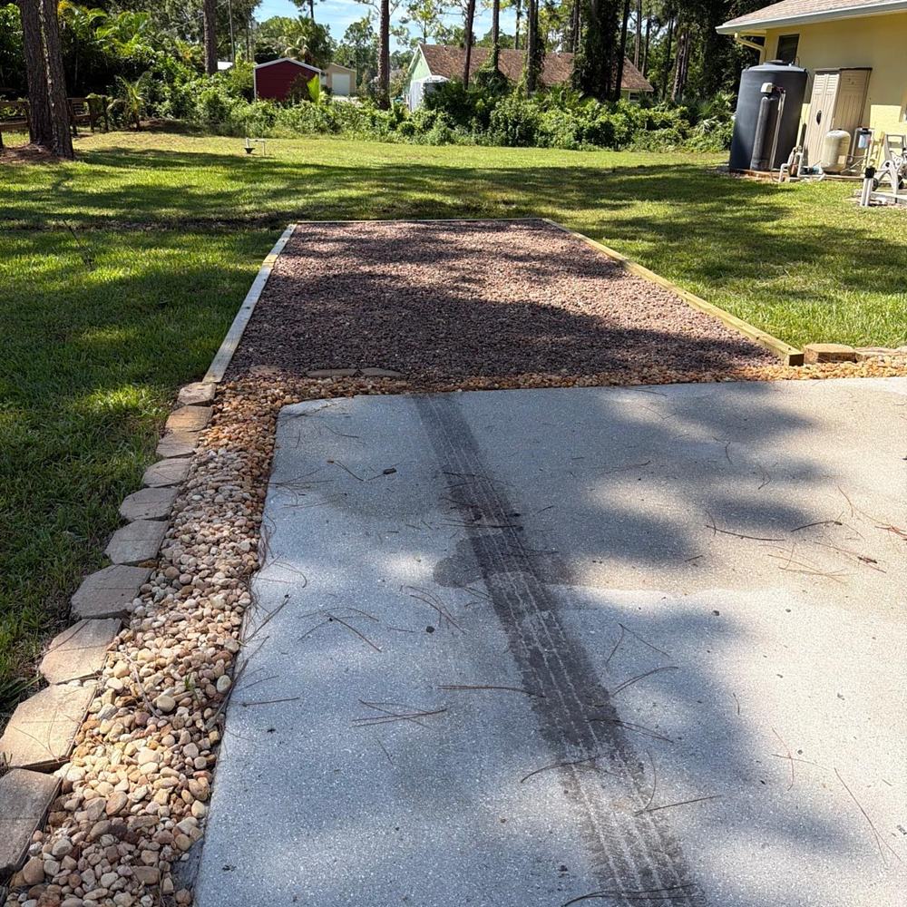 Gravel pad and driveway extension with stone edging in The Acreage, FL