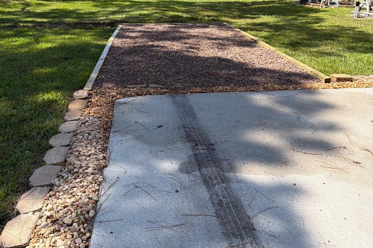 Gravel pad and driveway extension with stone edging installed in The Acreage, FL